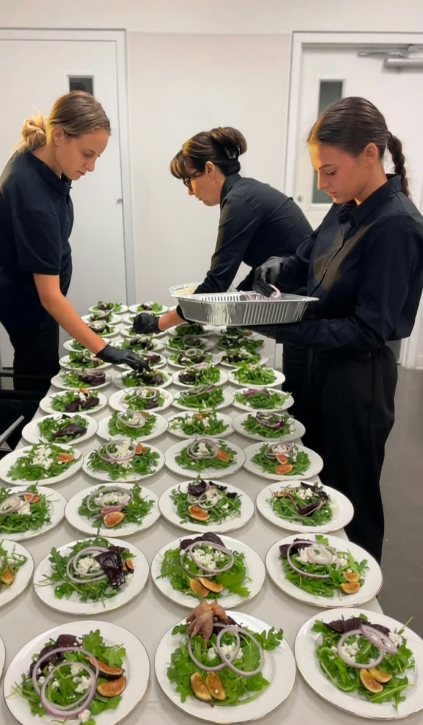Ellis Hospitality professionals plating salads for an event